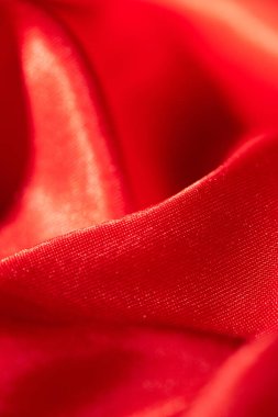 Soyut kırmızı ipek kumaş dokusu arkaplanı. Kumaş yumuşak dalga. Saten hazineleri.