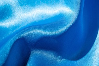 Soyut mavi ipek kumaş dokusu arkaplanı. Kumaş yumuşak dalga. Saten hazineleri.