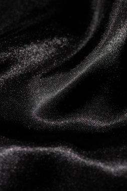 Soyut siyah ipek kumaş dokusu arkaplanı. Kumaş yumuşak dalga. Saten hazineleri.
