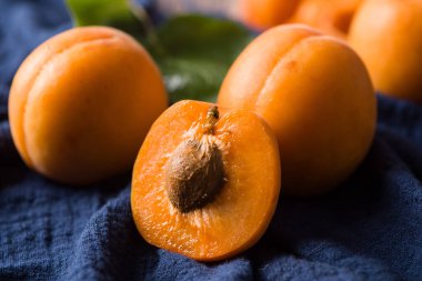  Fresh apricots fruit and half on wood background with clipping path