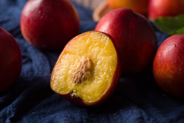 Group of whole nectarine fruits on wood background with clipping path