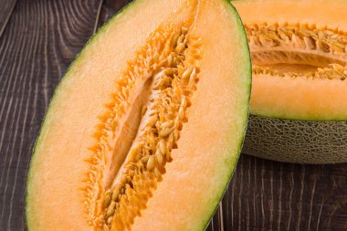 close-up of fresh Hami melon fruit on wooden background.