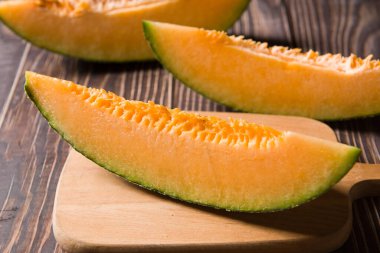 close-up of fresh Hami melon fruit on wooden background.