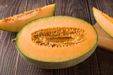 close-up of fresh Hami melon fruit on wooden background.