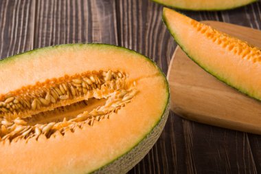 close-up of fresh Hami melon fruit on wooden background.