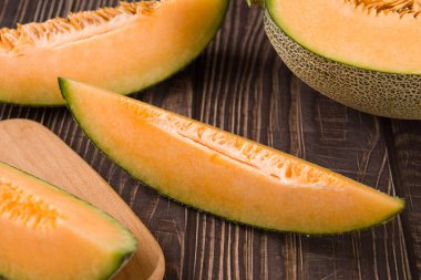 close-up of fresh Hami melon fruit on wooden background.