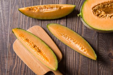 close-up of fresh Hami melon fruit on wooden background.