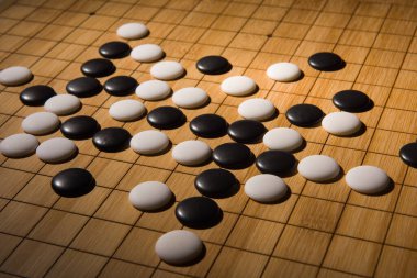 Desk for board game Go or Weiqi  and black and white bones. Traditional asian strategy boardgame