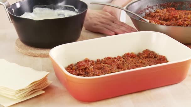 Meat sauce being covered with lasagne sheets — Stock Video