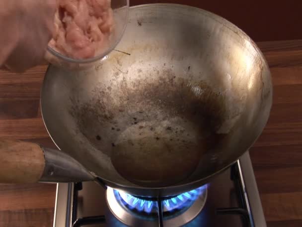 Sauteing chicken in a wok — Stock Video