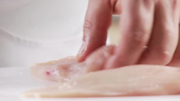 Sinews being cut away from chicken breasts — Stock Video