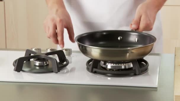 Орехи добавляются в антипригарную сковороду — стоковое видео
