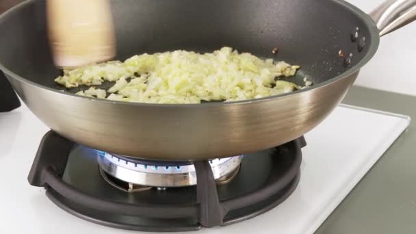 Onions and garlic being fried in a pan — Stock Video