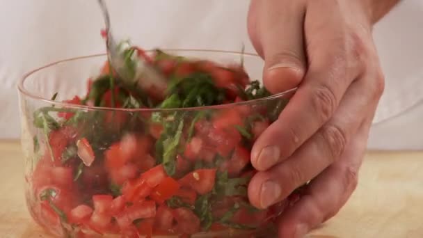 Basil and tomatoes being mixed — Stock Video