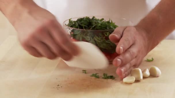 Basil and tomatoes being mixed — Stock Video