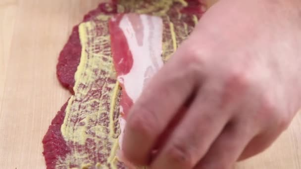 Beef roulade being filled with mustard — Stock Video