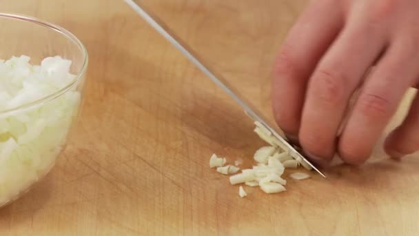 Chopping a garlic clove — Stock Video