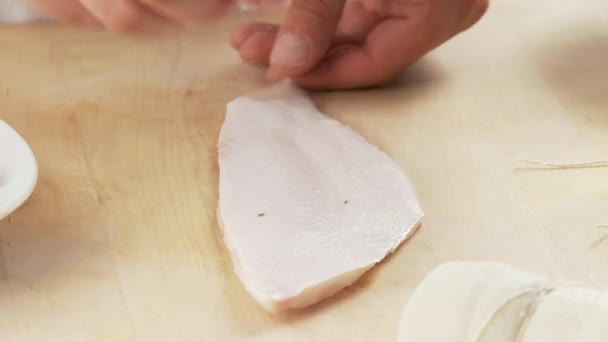 Plaice fillets being rolled up — Stock Video