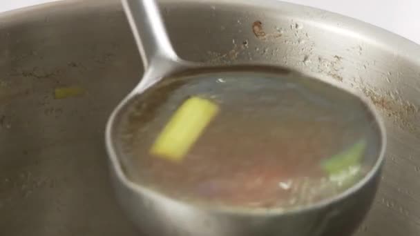 Beef stock being sieved — Stock Video