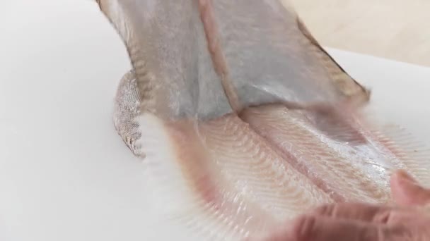 Chef removing the skin of sole fish — Stock Video