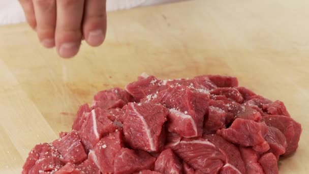 Meat being seasoned with salt — Stock Video