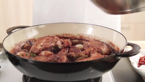 Mushrooms being added to coq au vin — Stock Video