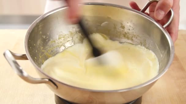 Cream being folded into egg yolks — Stock Video