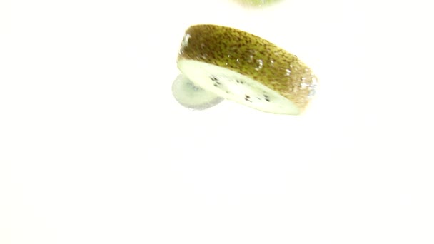 Slices of kiwi  floating in water — Stock Video