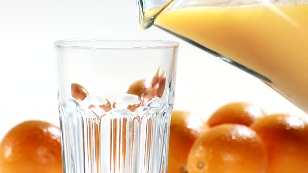 Pouring orange juice into a glass — Stock Video