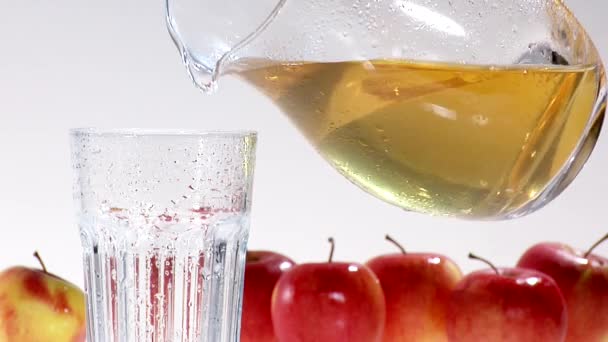 Pouring apple juice into glass — Stock Video