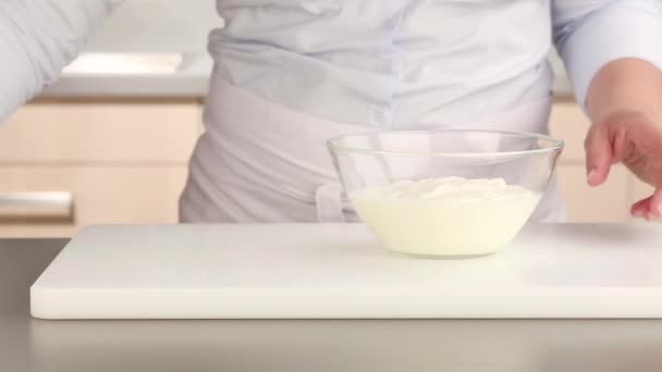 Ginger being grated into yogurt — Stock Video