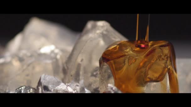 Herb liqueur being poured over ice — Stock Video