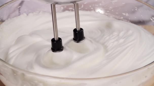 Egg whites being beaten with a hand mixer — Stock Video