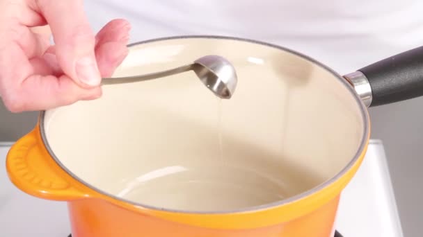 Oil being added to a saucepan — Stock Video