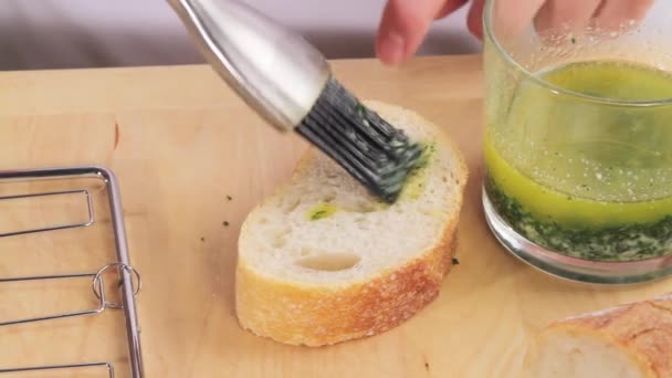Baguette being brushed with liquid butter — Stock Video