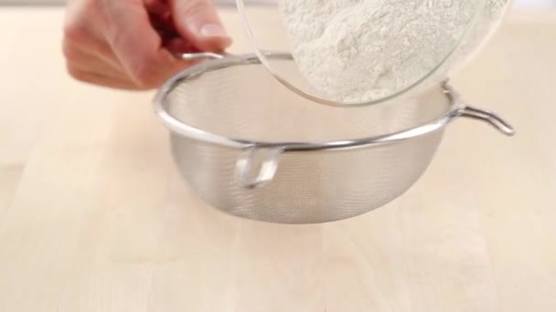 Sieving flour onto a work surface — Stock Video