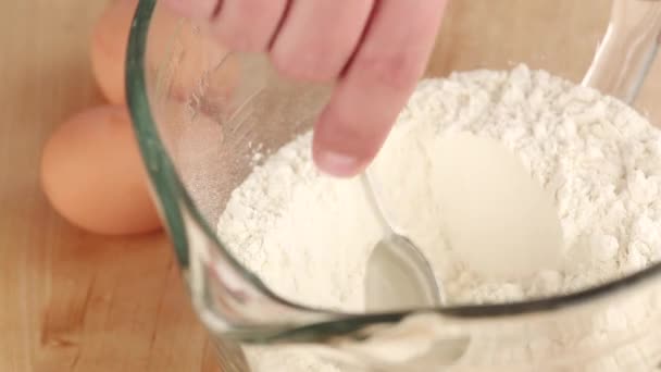 Egg being added to a flour well — Stock Video