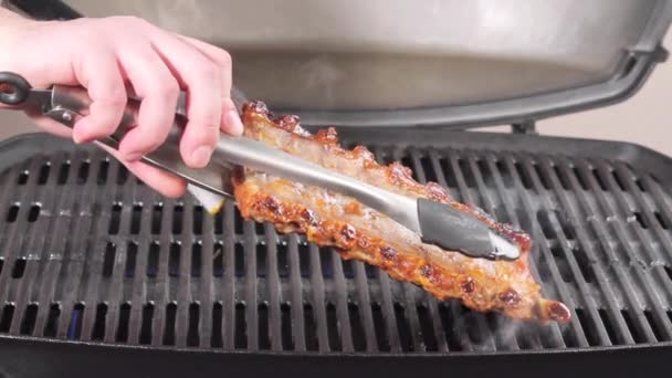 Marinerade revbensspjäll på en grill — Stockvideo