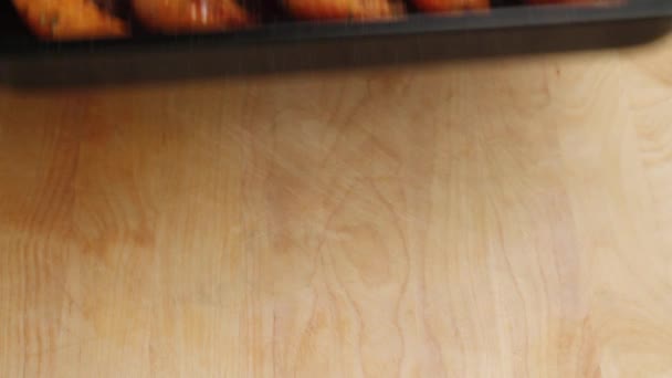 Roast pumpkin wedges on a baking tray — Stock Video