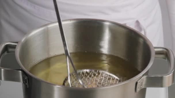 Removing calamari from oil — Stock Video