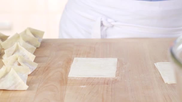 Won ton sheets being filled with a pork — Stock Video