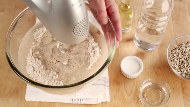 Ingredients for bread dough being kneaded — Stock Video