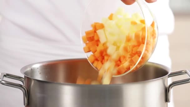 Vegetables being added to a pot — Stock Video