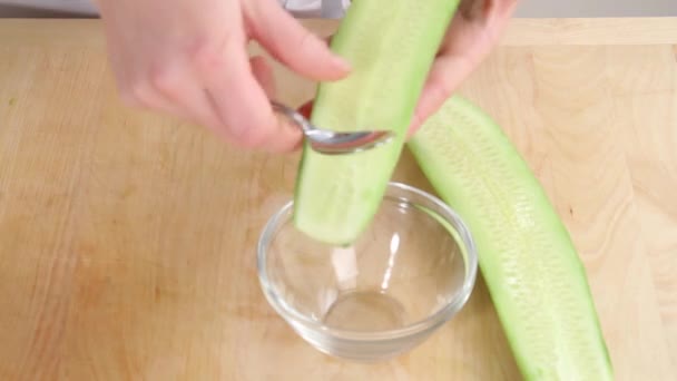 Deseeding cucumber with spoon — Stock Video