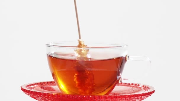 Stirring a cup of tea with a sugar swizzle stick — Stock Video