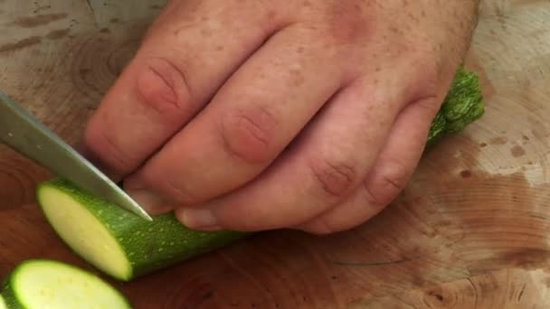Skivning en zucchini på skärbräda — Stockvideo