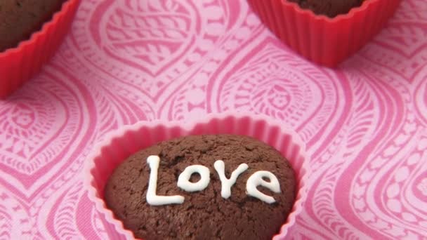 Magdalenas de chocolate en forma de corazón con la escritura de azúcar — Vídeos de Stock