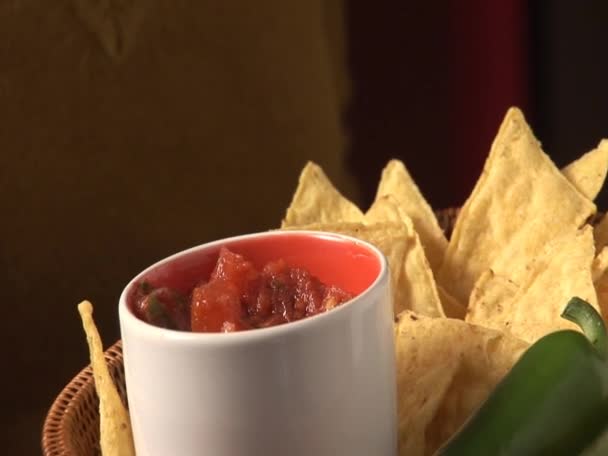 Dipping nachos in tomato salsa — Stock Video