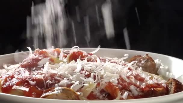 Sprinkling Parmesan and parsley over ribbon pasta — Stock Video