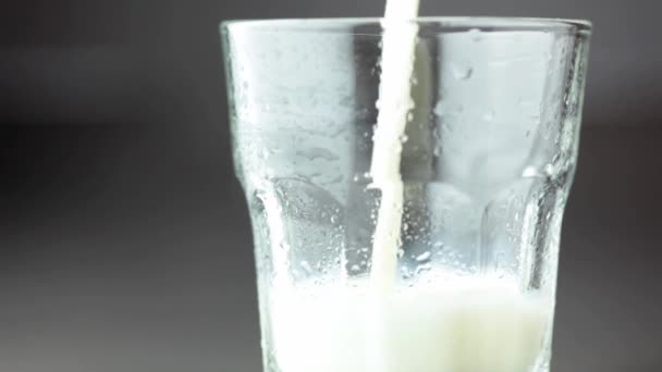 Pouring strawberry milk into a glass — Stock Video